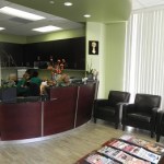 Dr. Margossian's waiting room for patients with reading materials and chairs in front of the front desk